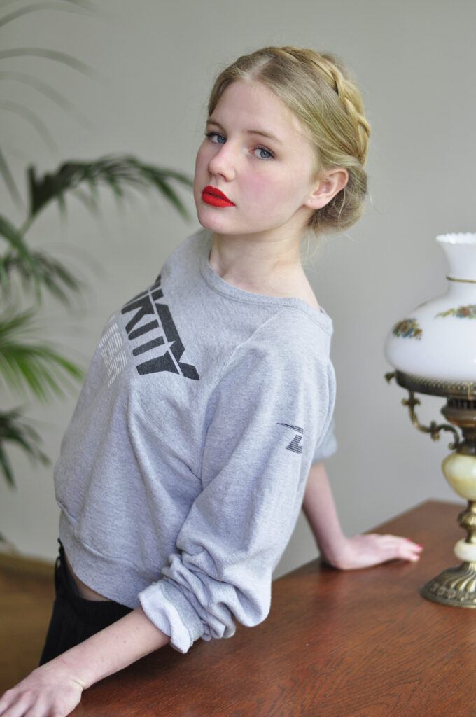 girl in sweatshirt in mid-century apartment