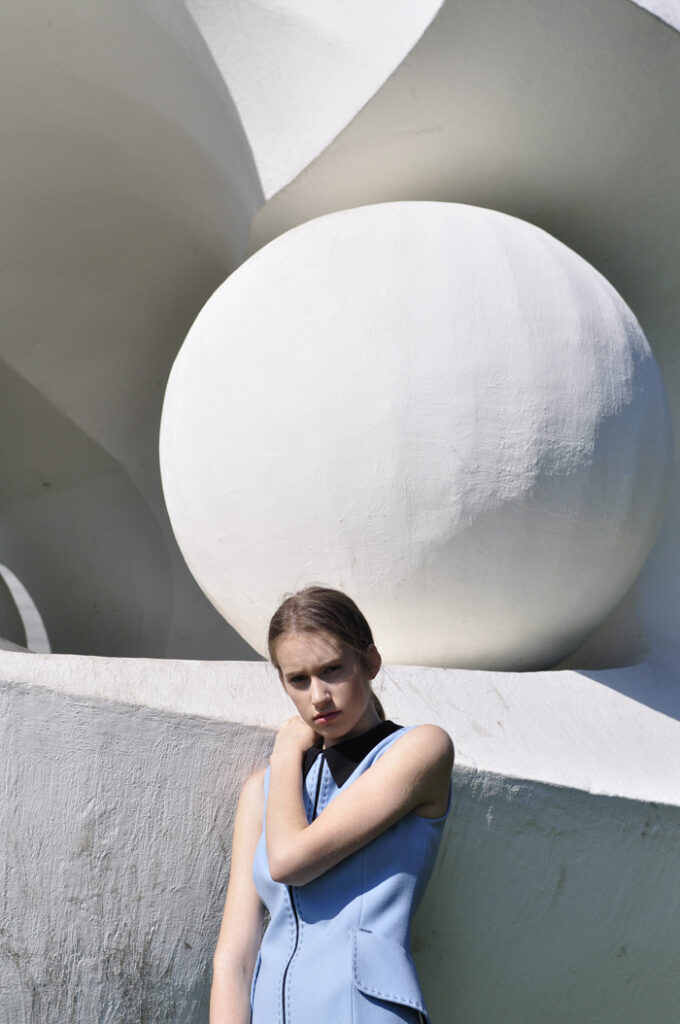 woman in front of white sculpture